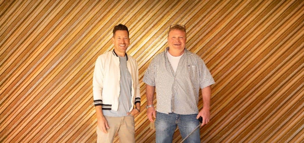 Luke Caldwell and Clint Robertson standing in front of a wall of wood moldings