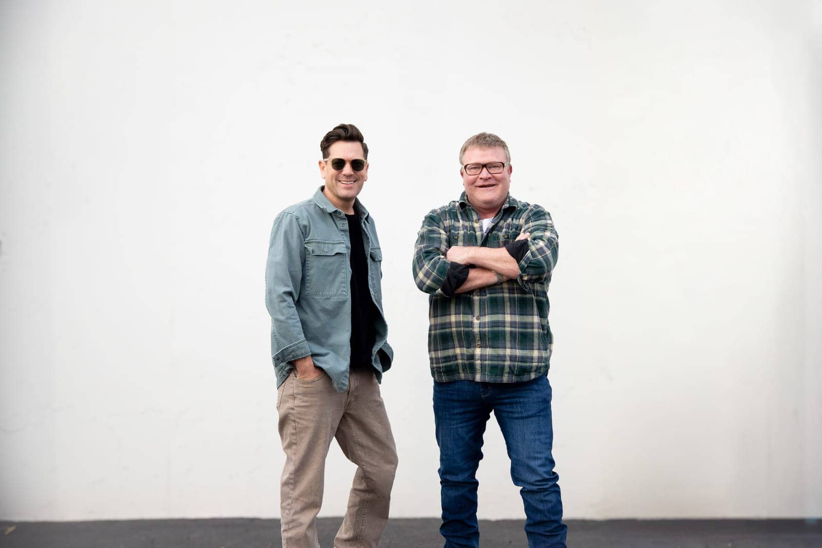 Luke Caldwell and Clint Robertson standing side by side, Clint with his arms crossed