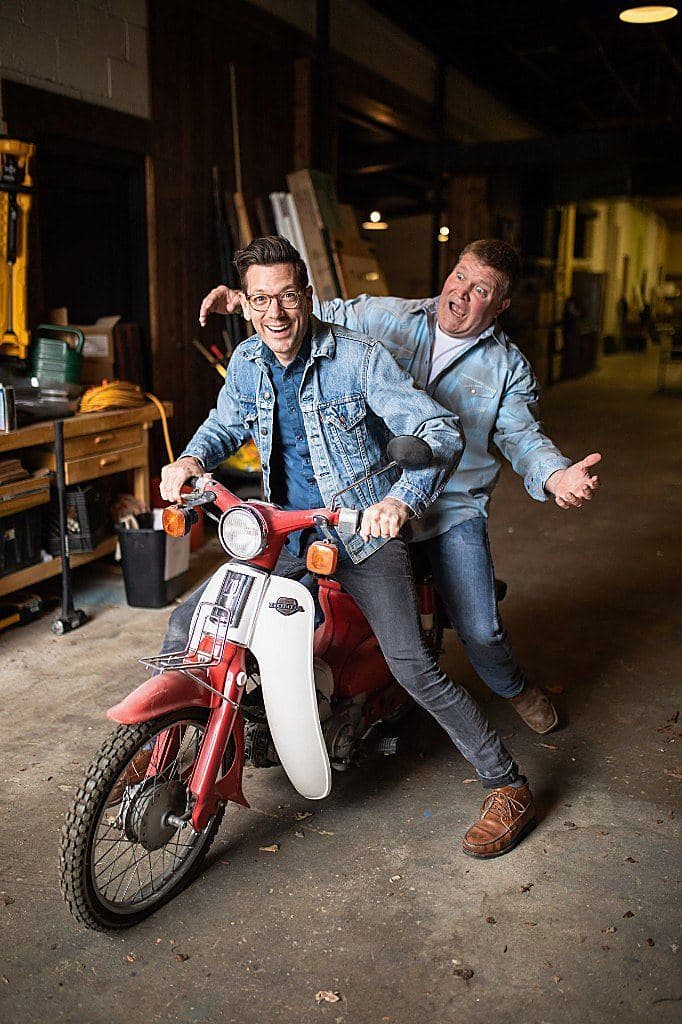 Luke Caldwell and Clint Robertson on a vintage scooter in a workshop