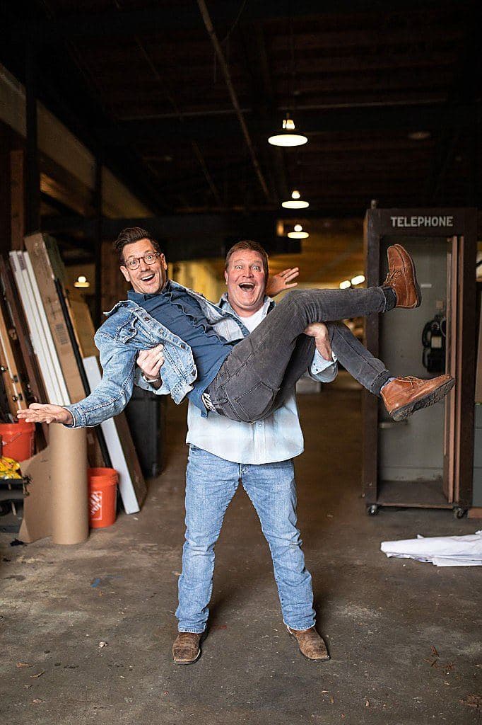 Clint Robertson carrying Luke Caldwell through a workshop