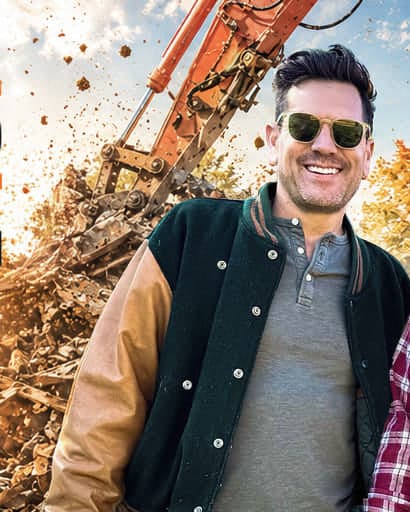 Luke Caldwell, the designer half of The Boise Boys, in a varsity jacket and sunglasses on a demolition site